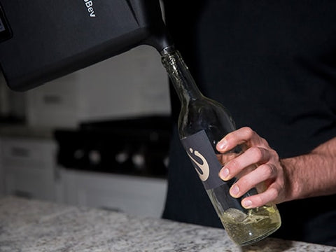 A happy wine enthusiast pouring wine from the ProntoBev back into the bottle.
